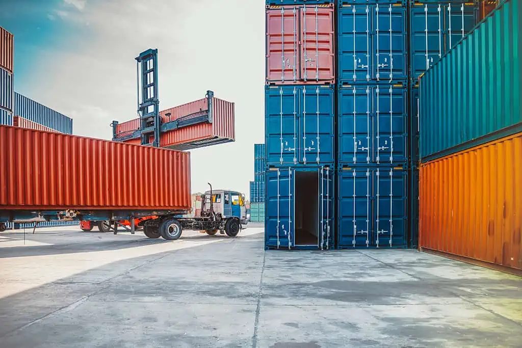 Container yard with a reach stacker handling freight