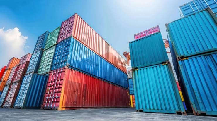 Colourful import containers stacked at a customs terminal