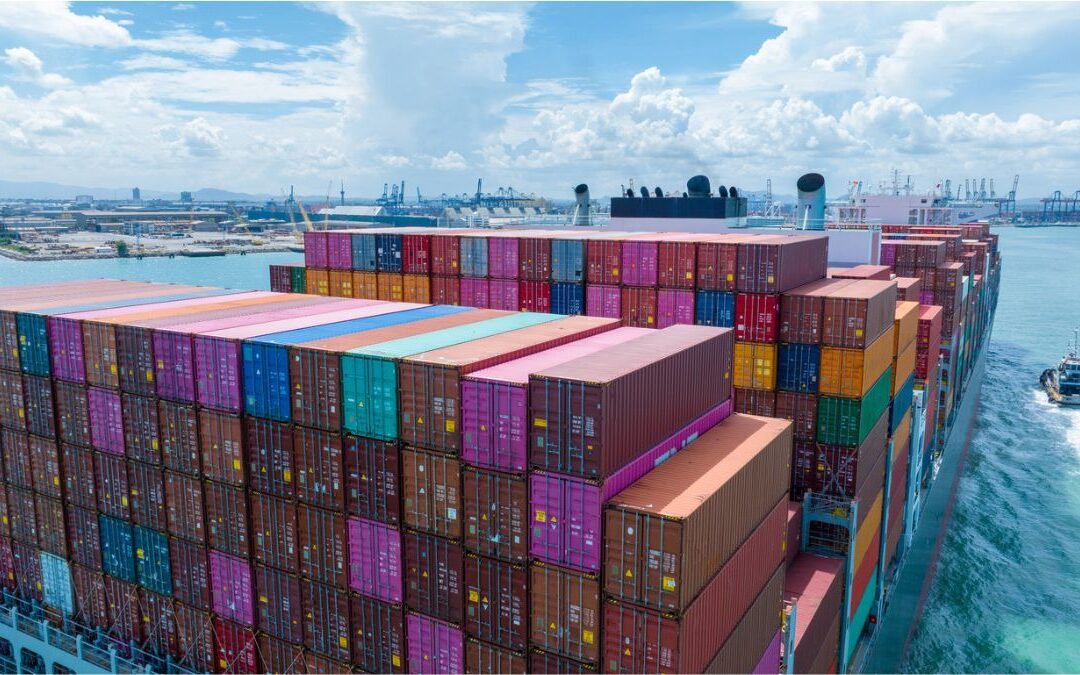 Colourful shipping containers stacked on a sea-freight vessel