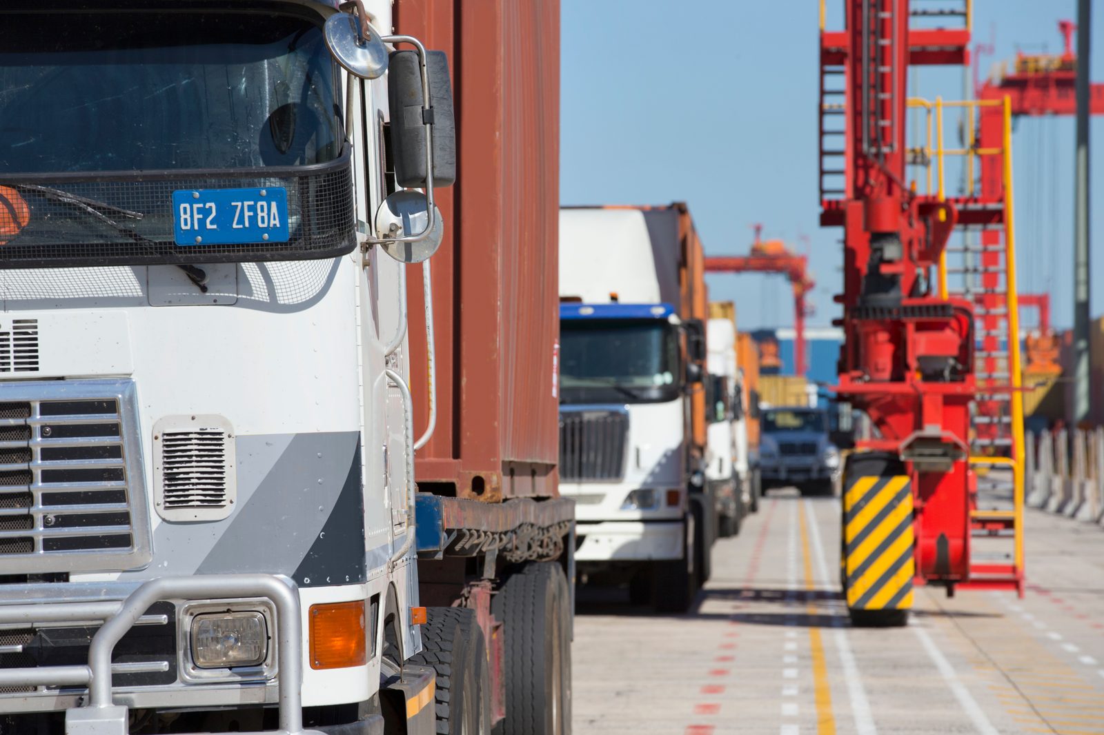 Freight truck collecting a shipping container at a dockyard
